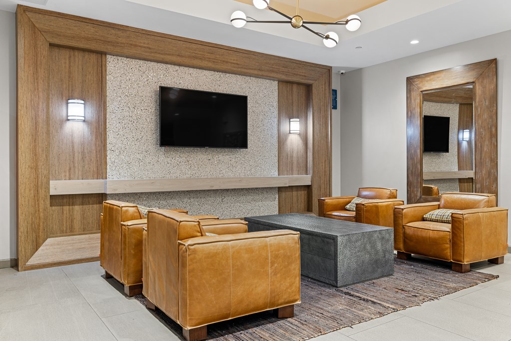 A modern living room with a flat screen TV mounted on the wall.