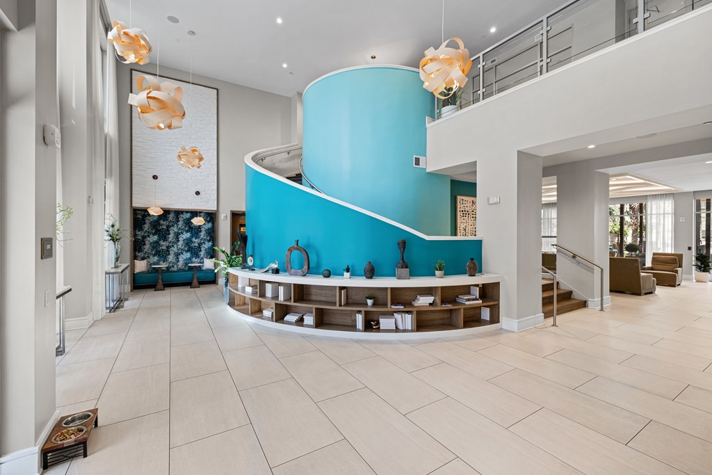 A blue spiral staircase in a white and blue themed interior.