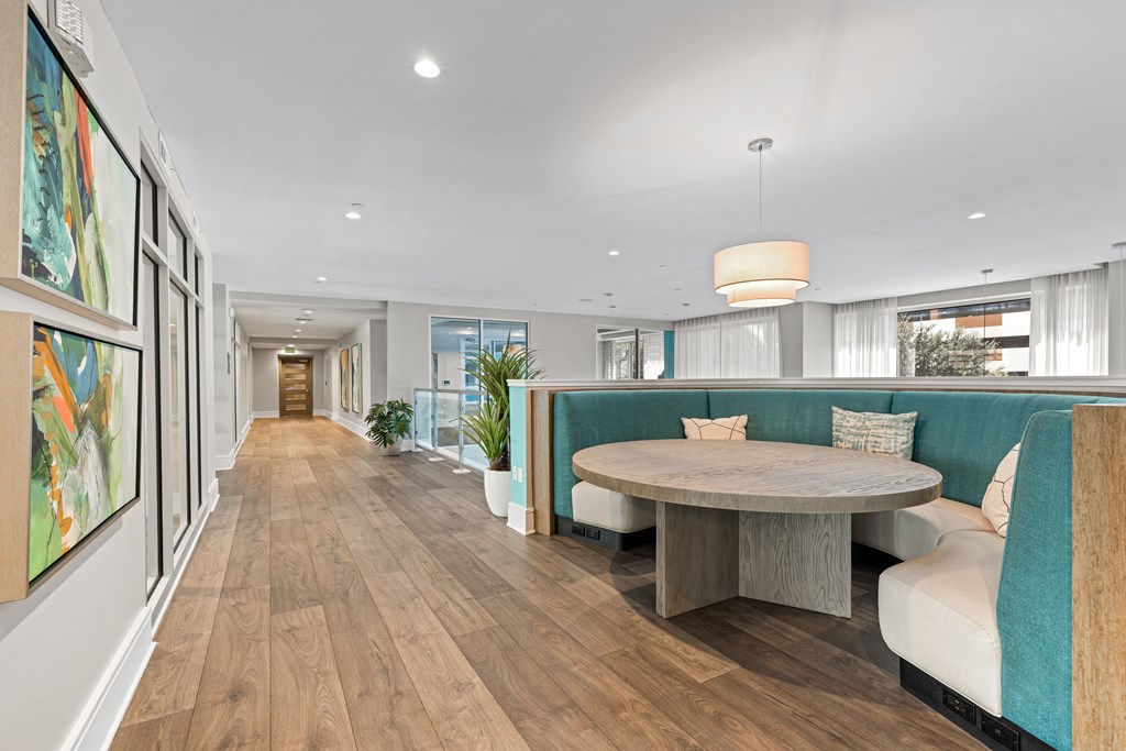 A long, narrow room with a table and chairs in the middle.