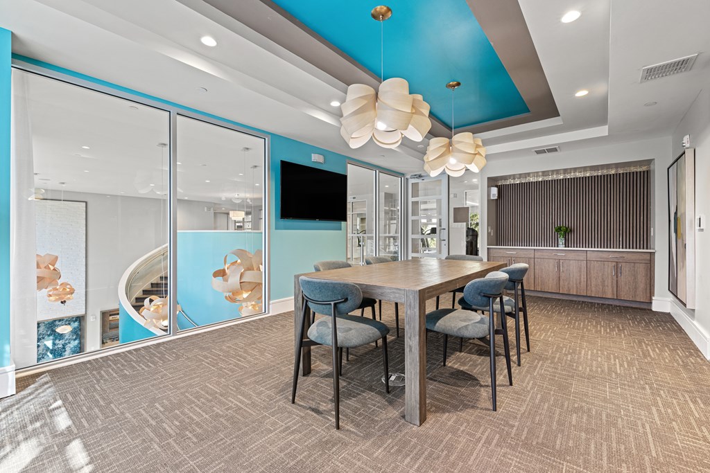 A modern dining room with a wooden table and chairs.