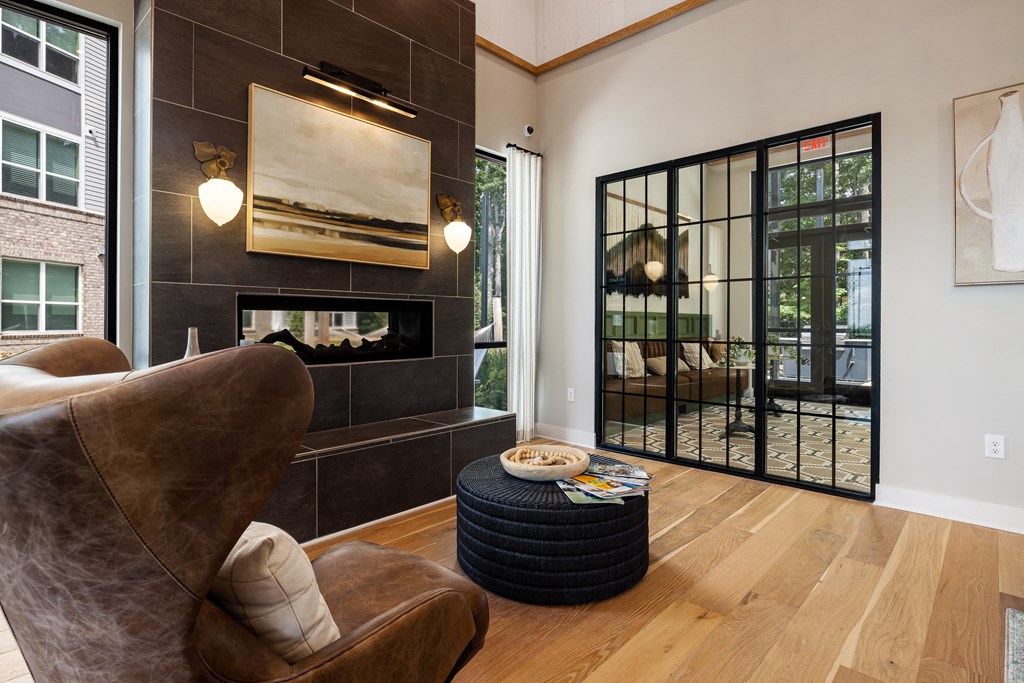 a living room with a couch and chair and a fireplace