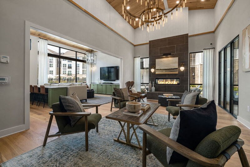 a living room with a large fireplace and a chandelier