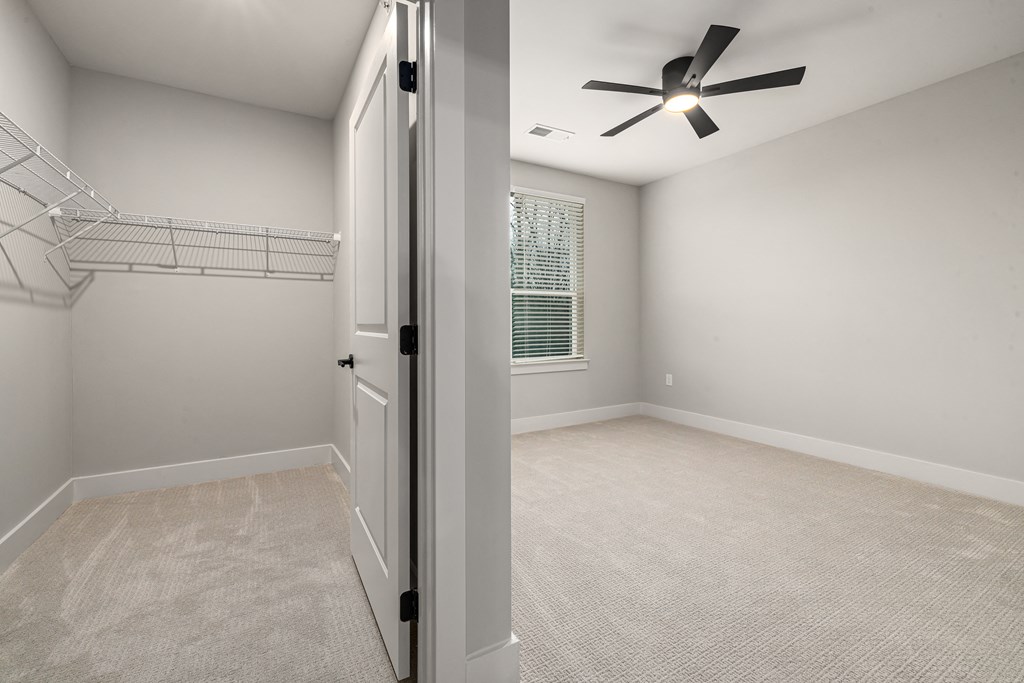 large white bedroom with ceiling fan