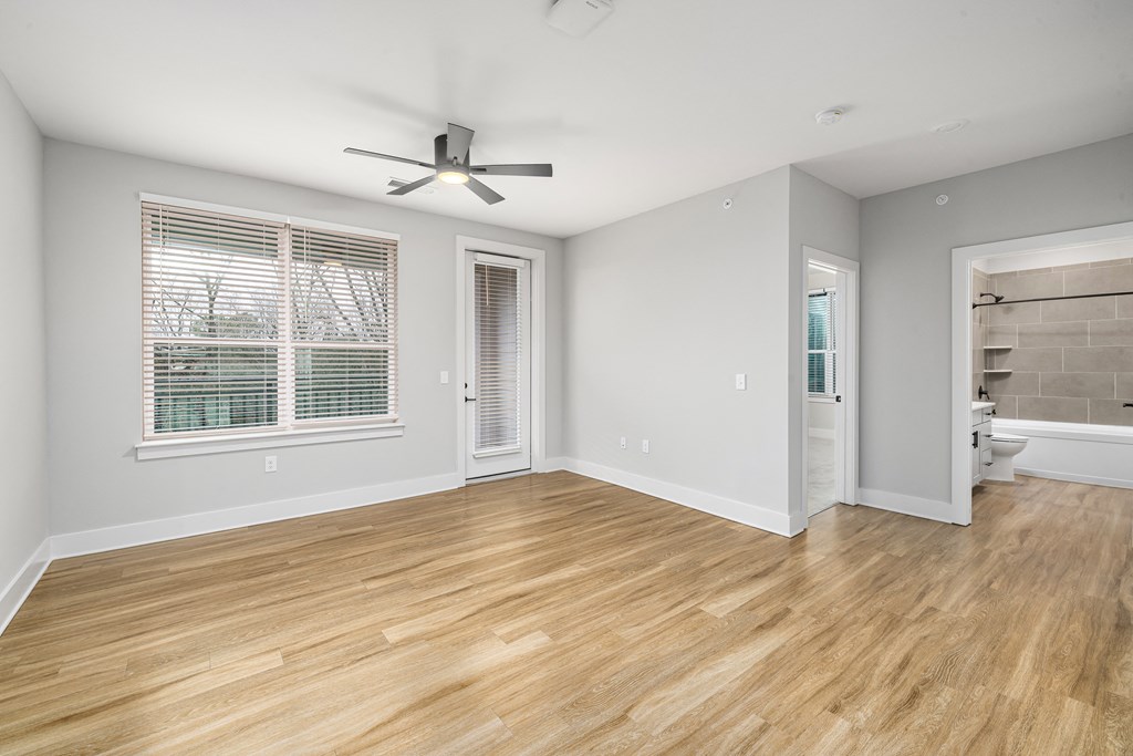 large bedroom with brown wooden floor