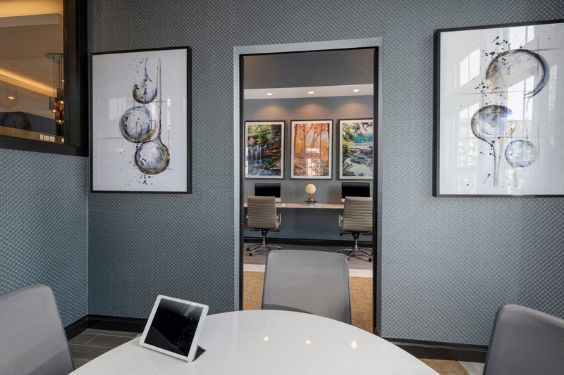 a conference room with a table and chairs and a on the table