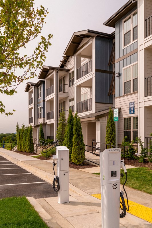 an apartment building with electric meters in front of it