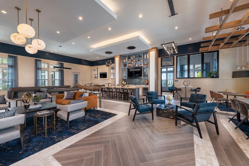 the lobby of a hotel with couches and tables and chairs