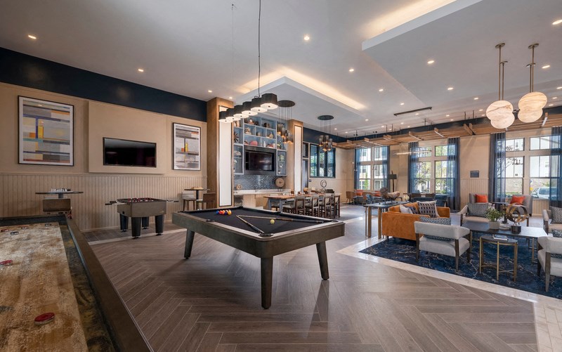a spacious game room with a pool table and a television
