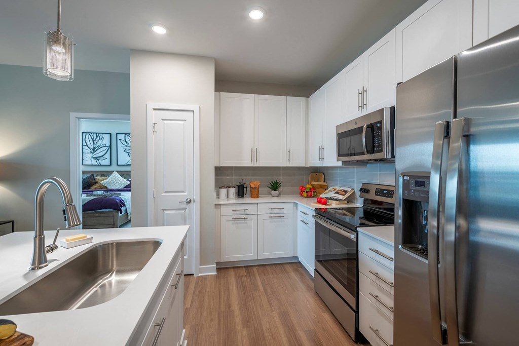 a kitchen with stainless steel appliances and white cabinets
