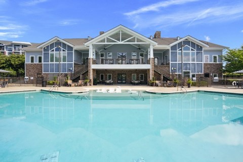 A large house with a pool in front.
