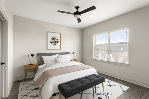 a bedroom with a large bed and a ceiling fan