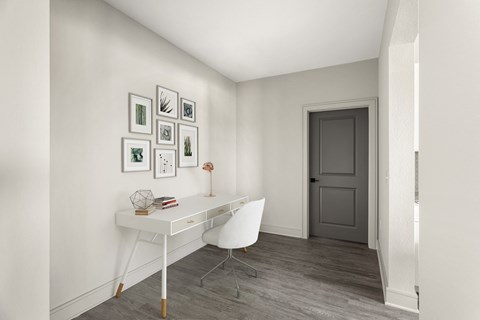 a home office with a white desk and a white chair in a 555 waverly unit