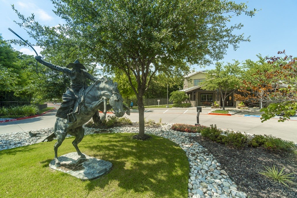 a statue of a man riding a horse in a park