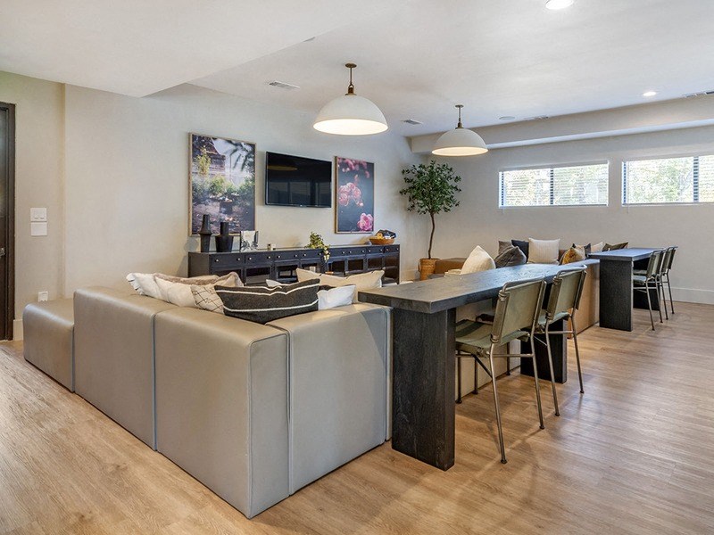 the living room and dining area of a home with a table and chairs