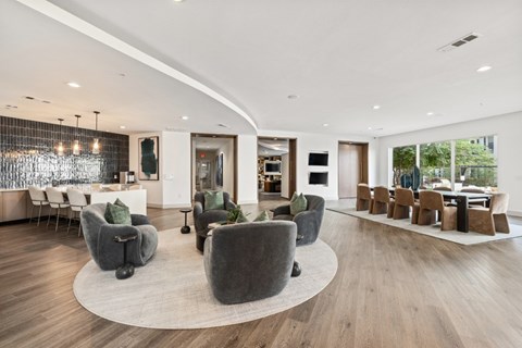 A modern living room with grey chairs and a wooden floor.