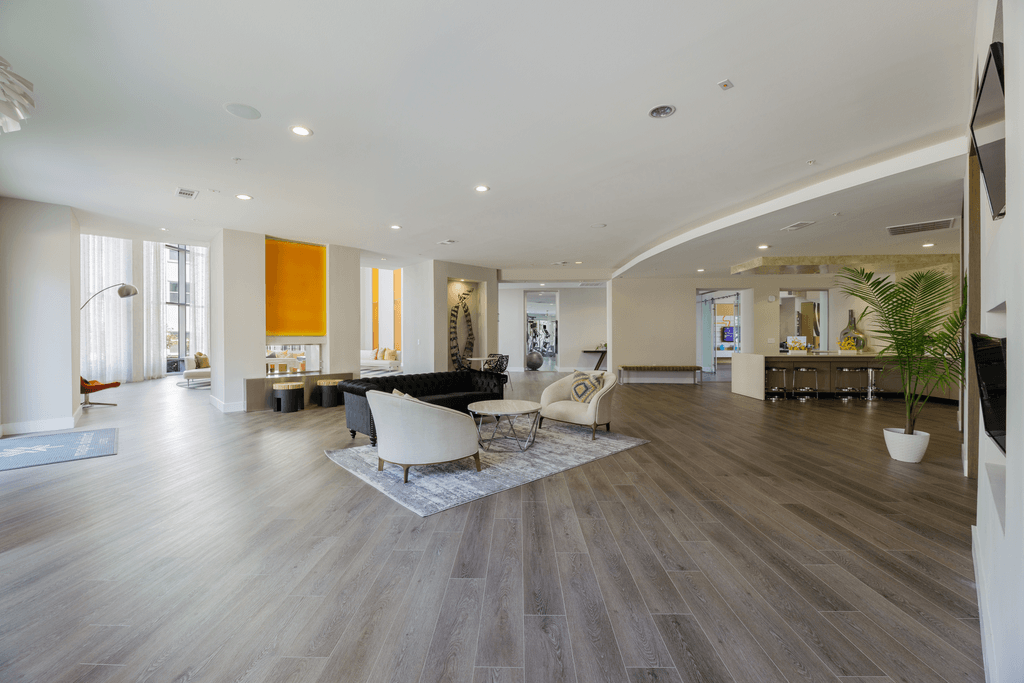 A spacious living room with a grey floor and a white ceiling.