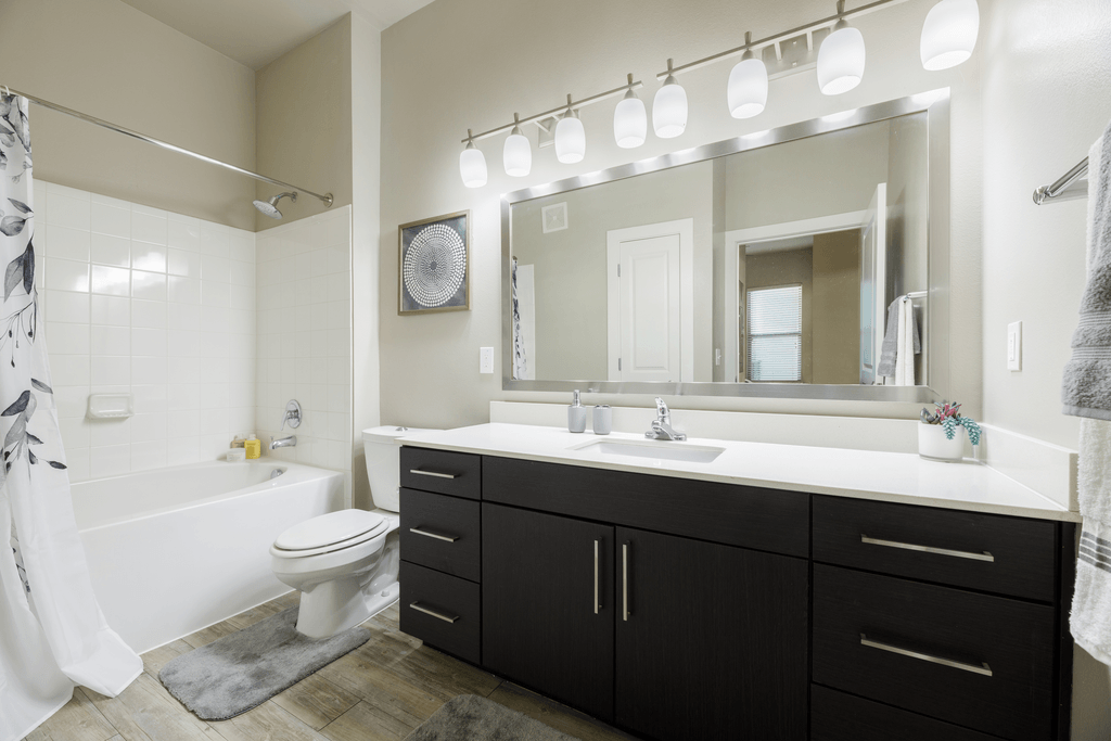 A bathroom with a white toilet, a white sink, and a white bathtub.