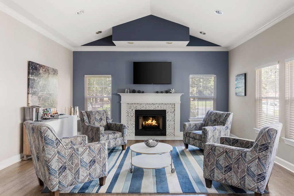 a living room with blue and white furniture and a fireplace