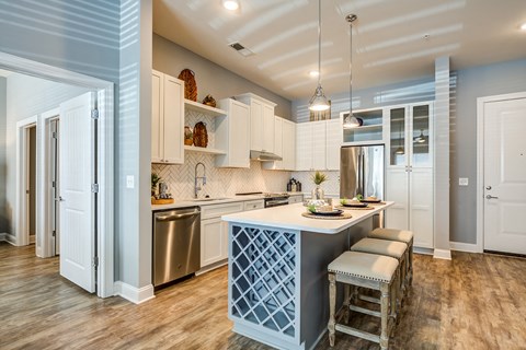 a kitchen with a blue island and white cabinets