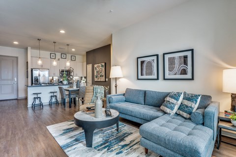 a living room with a blue couch and a coffee table
