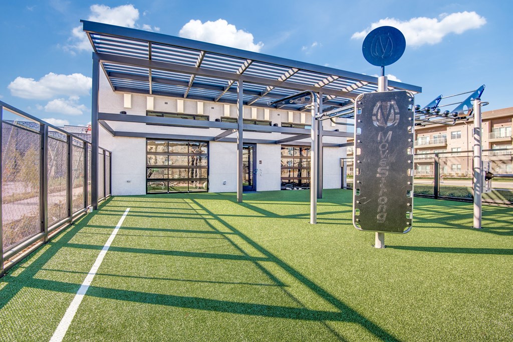 a tennis court with a sign in front of a building