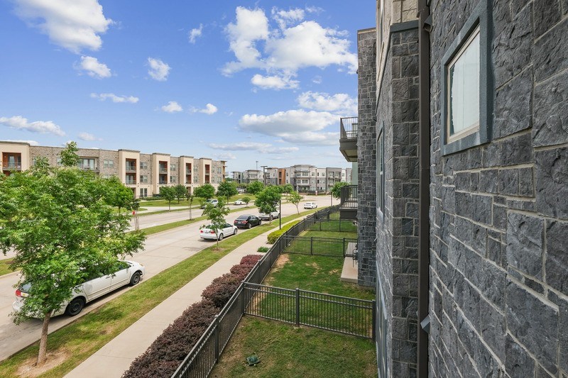 A row of houses with a car parked in front of one.
