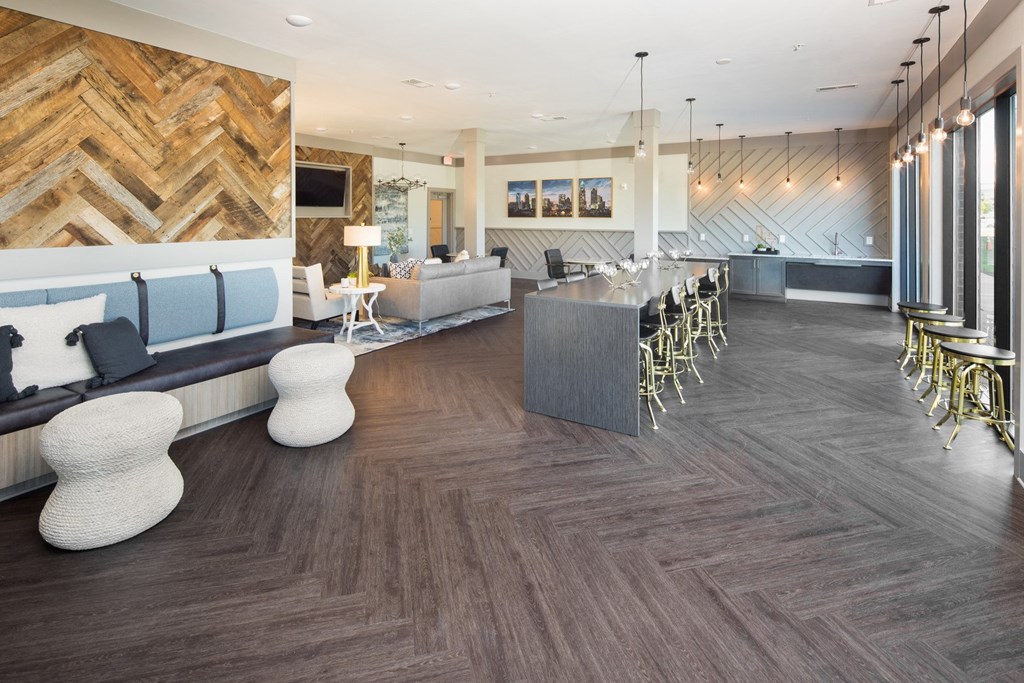 the lobby of a hotel with a bar and seating area