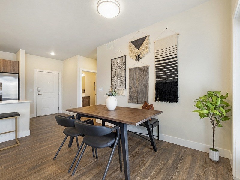 a dining room with a table and chairs and a kitchen