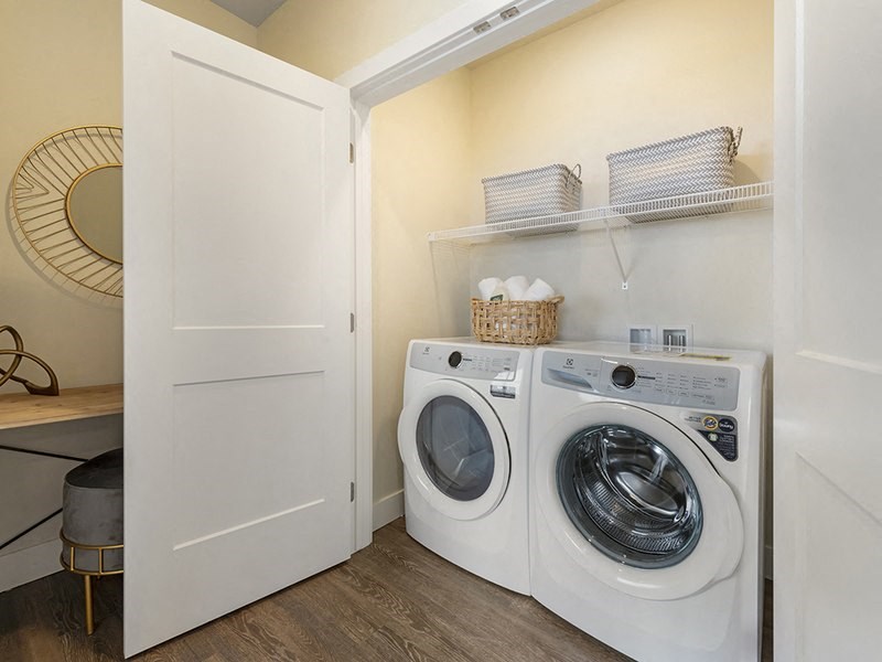a washer and dryer in a laundry room with a closet