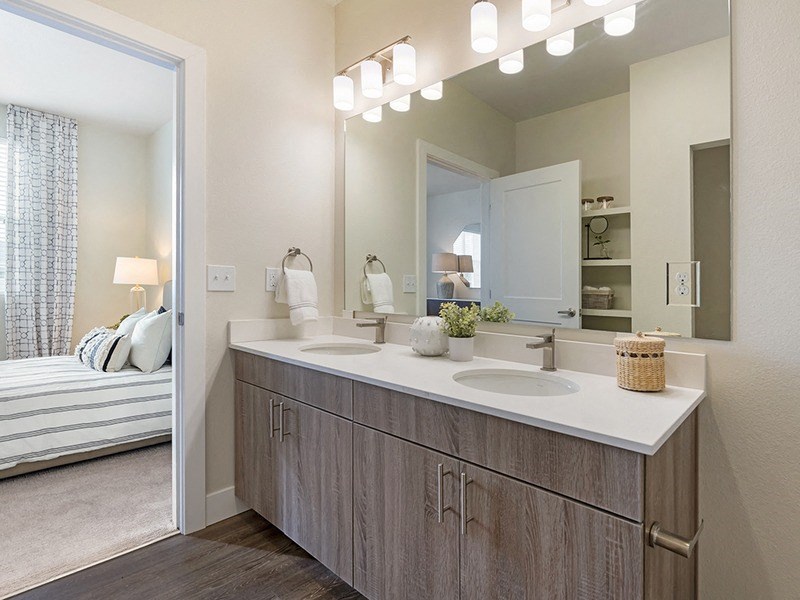 an open bathroom with two sinks and a mirror