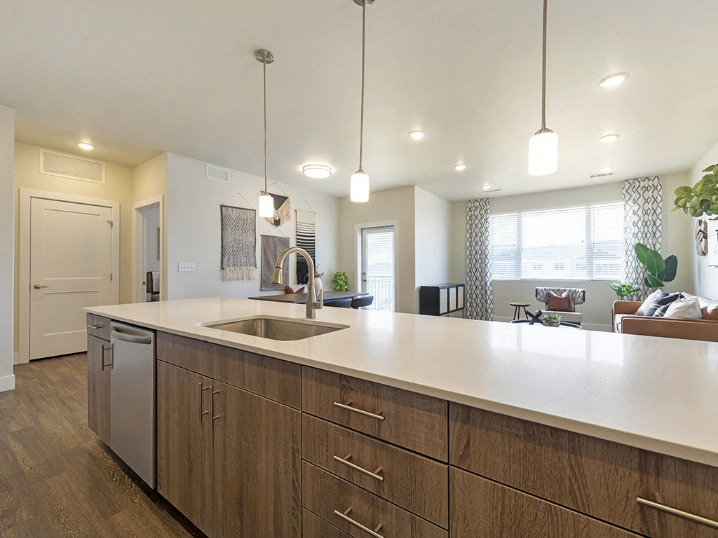 a kitchen with a sink and a counter top in a house