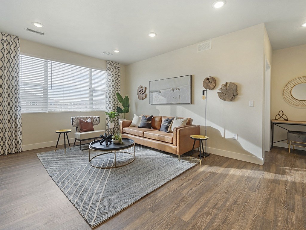 an open living room with a couch and a rug