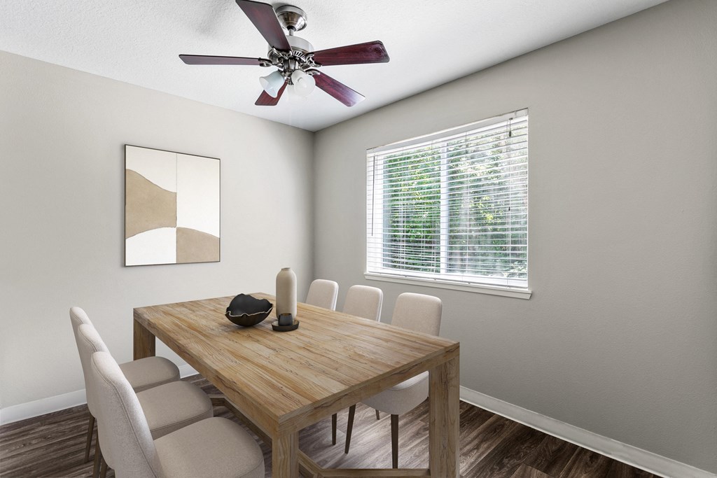 a dining room with a table and chairs and a ceiling fan
