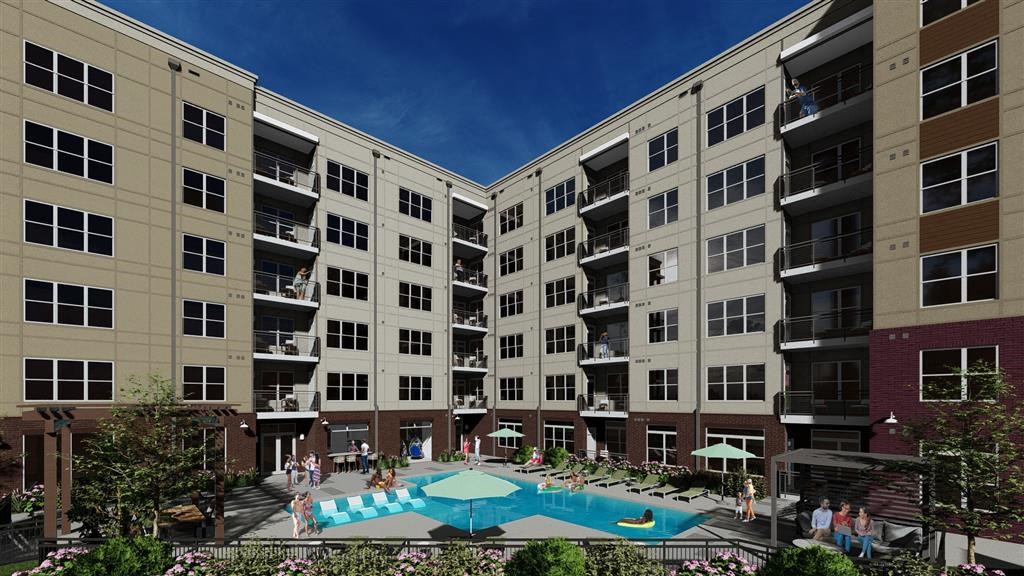 A large apartment complex with a pool in the middle.