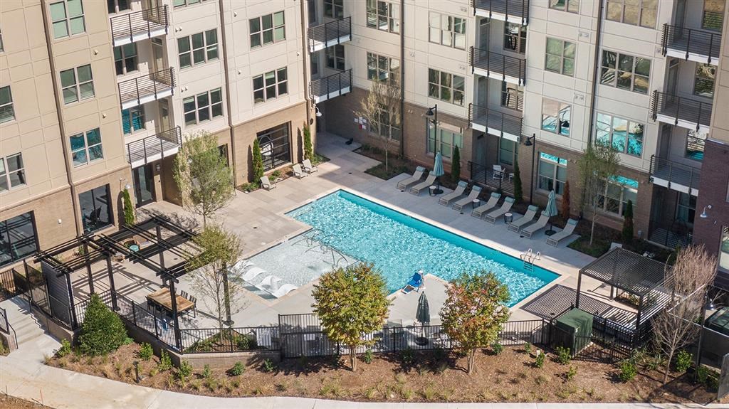 A swimming pool surrounded by apartment buildings.
