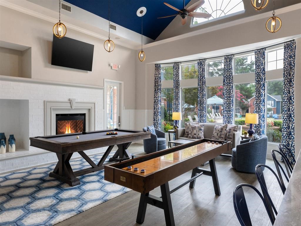 a game room with a pool table and a fireplace