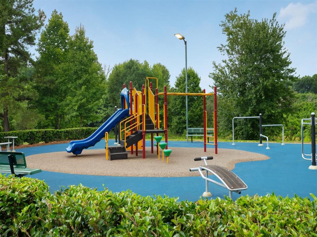 a playground with a slide and other toys in a park
