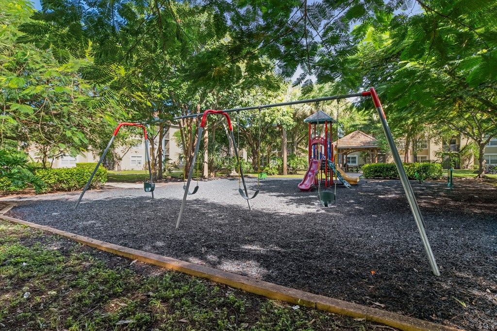 A playground with a swing set and a slide.