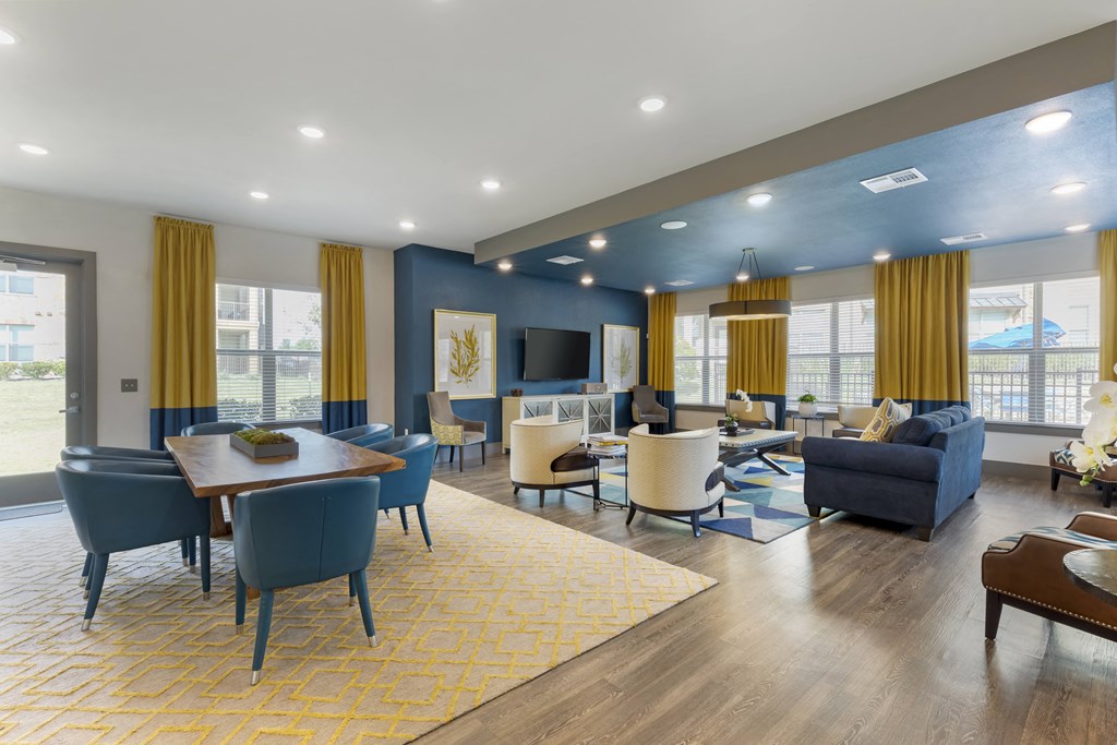 a living room with couches chairs and tables and a television