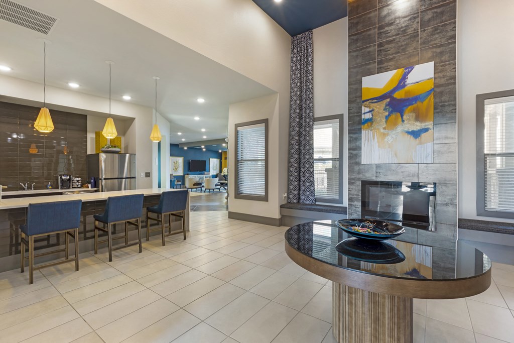 a living room with a fireplace and a table with chairs