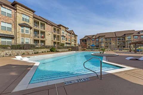 a pool with buildings behind it