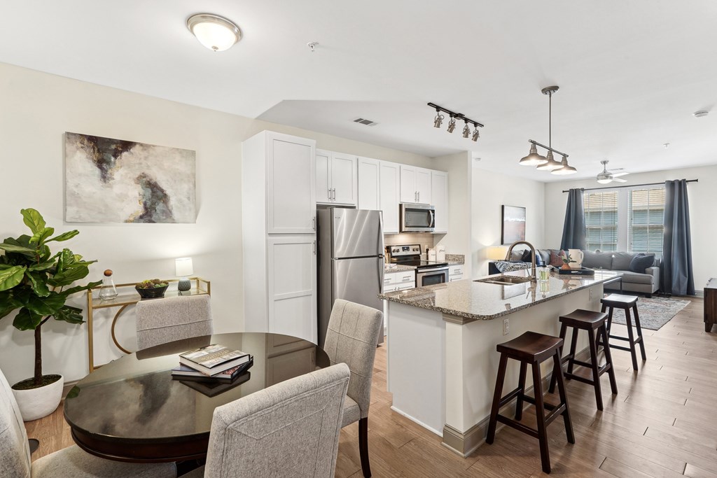 a living room with a kitchen and a dining table
