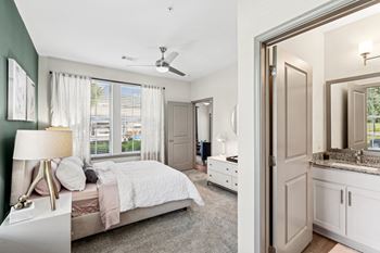 A bedroom with a bed, dresser, and mirror.