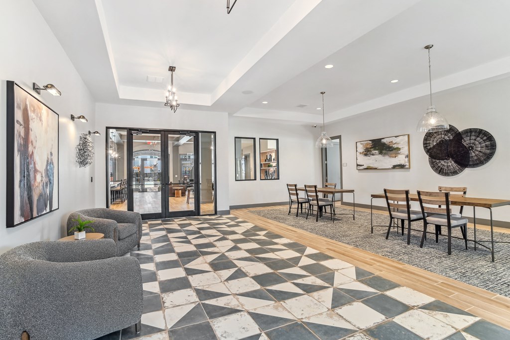 a living room with a checkered floor and a dining room table and chairs