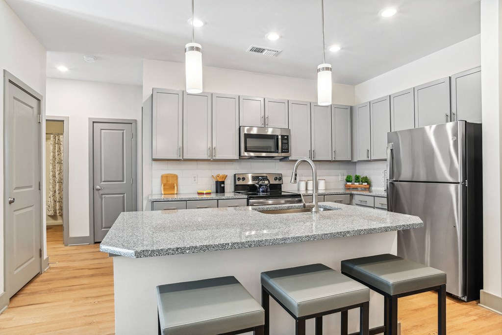 a kitchen with a marble counter top and stainless steel appliances