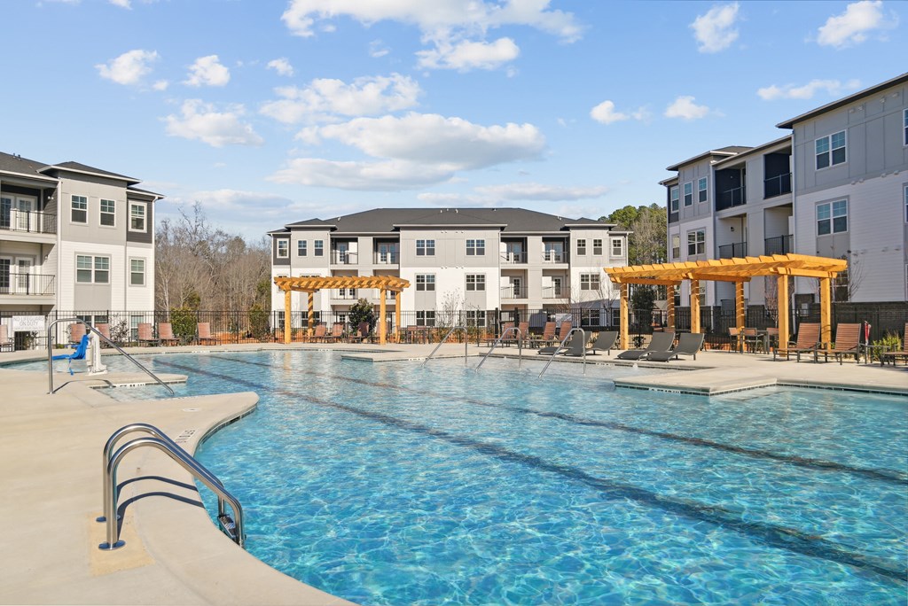 a swimming pool with an apartment building in the background