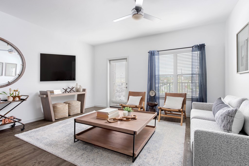 A living room with a television, a coffee table, and a couch.