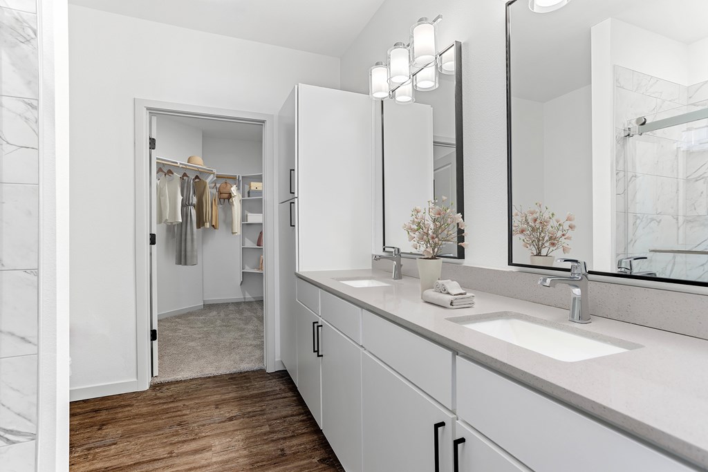 A bathroom with a white sink and a mirror.