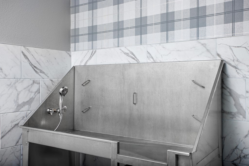 A shower stall with a shower head and a faucet.