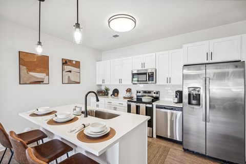 a kitchen with stainless steel appliances and a white counter top